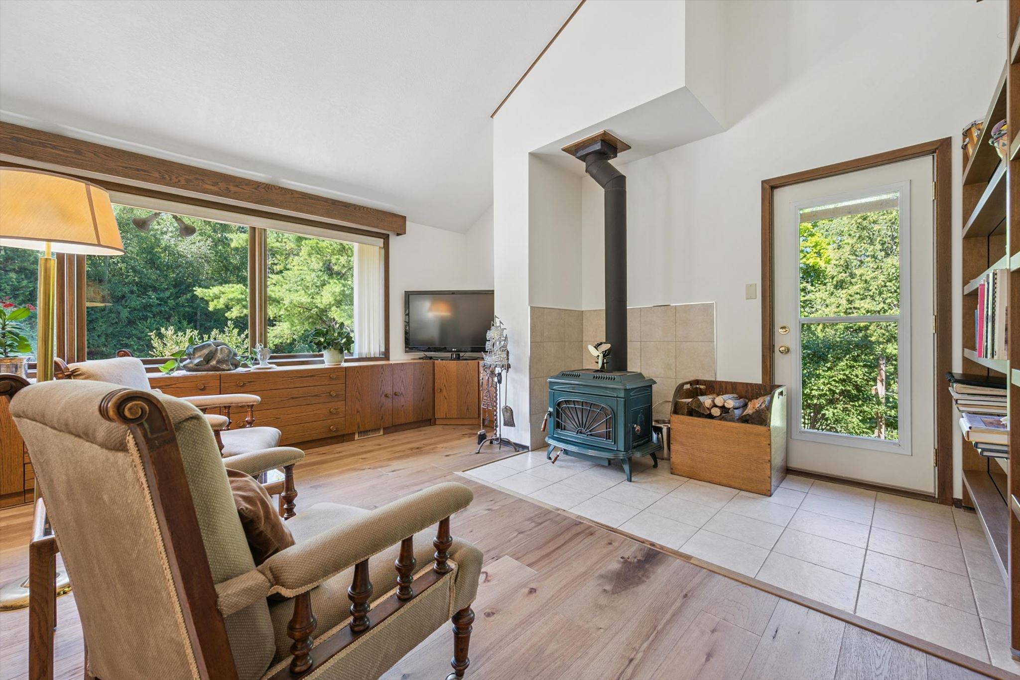 Wood stove on a tiled hearth, with garden door alongside