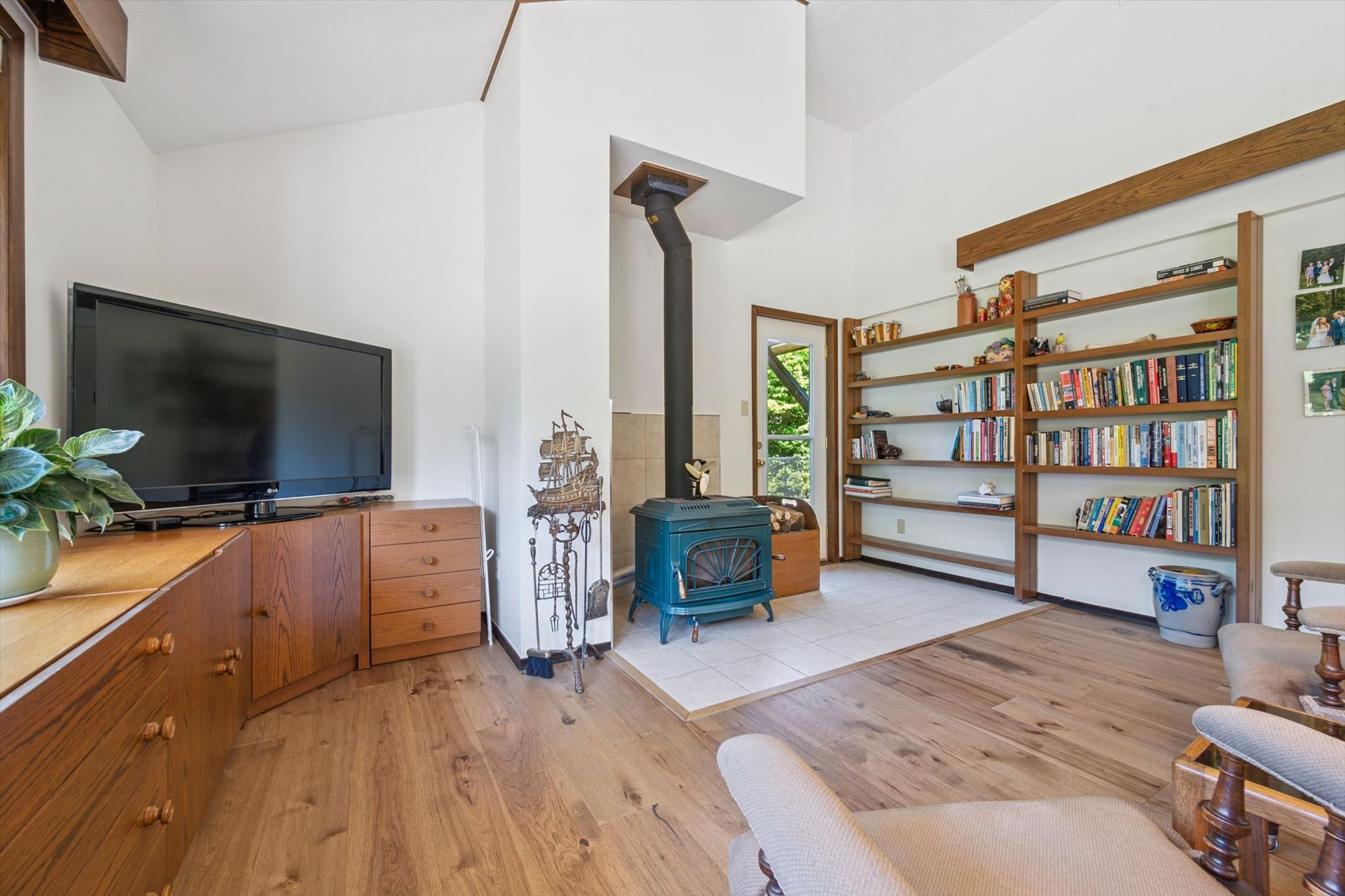 Built-in oak shelving beside the wood stove