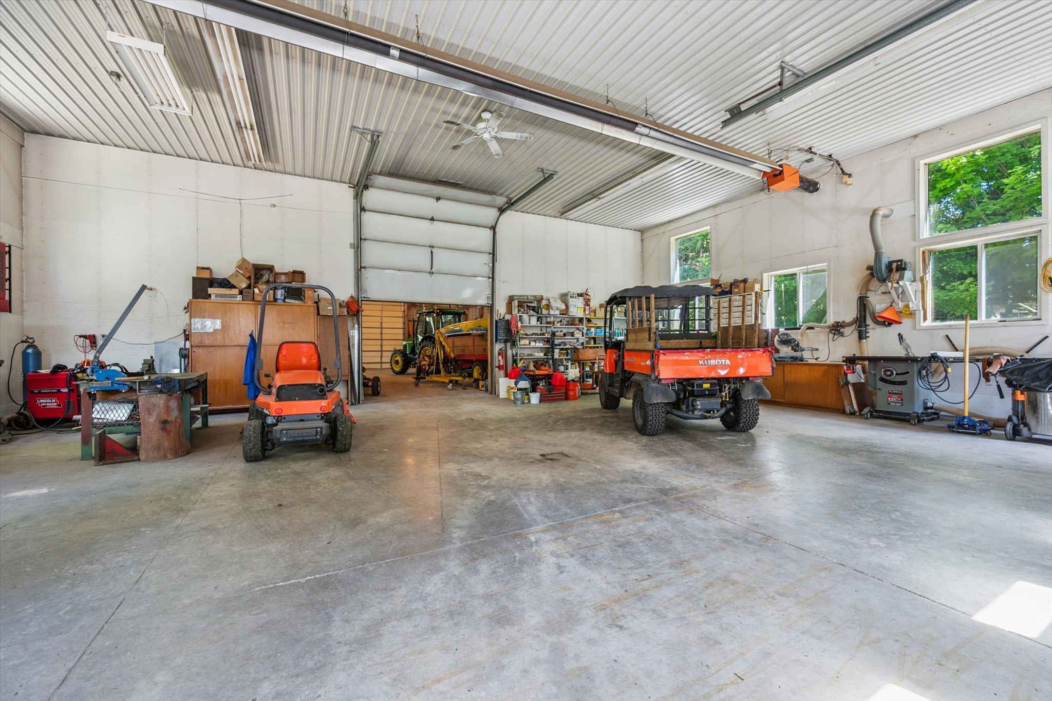 Woodworking and metalworking stations along the workshop walls