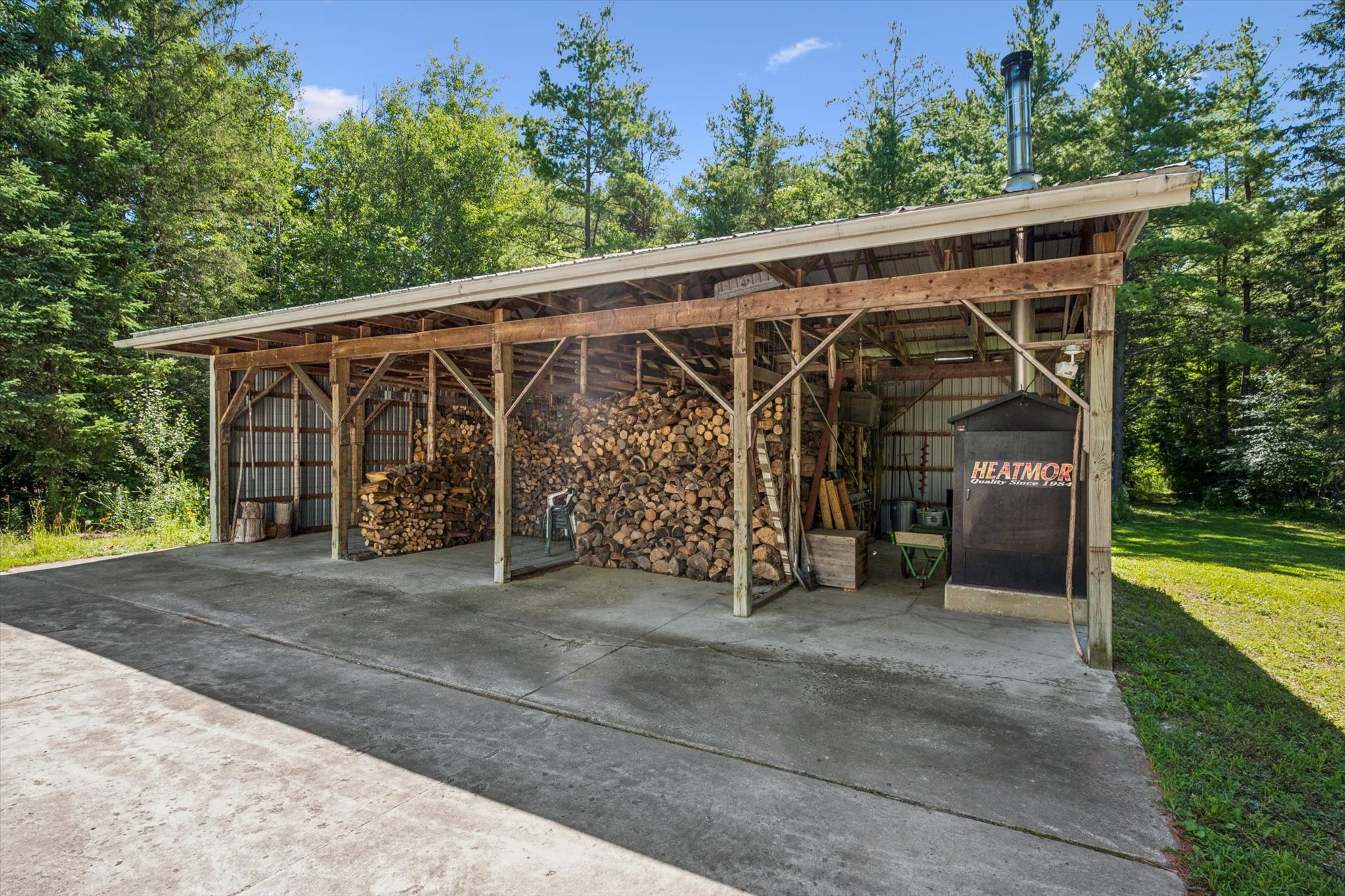 The woodshed and the outdoor wood furnace that heats the house