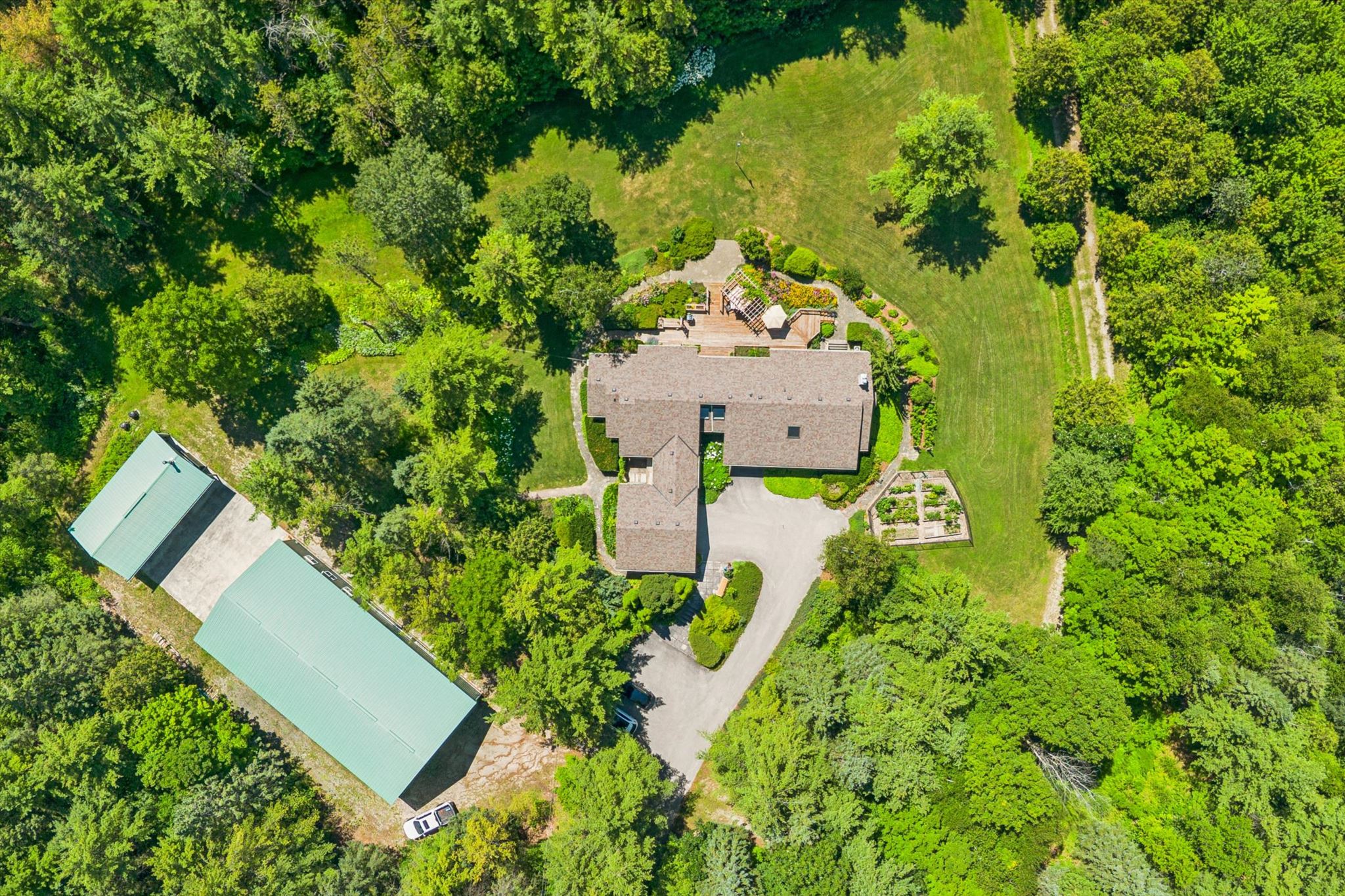 Directly above the house, outbuildings and gardens